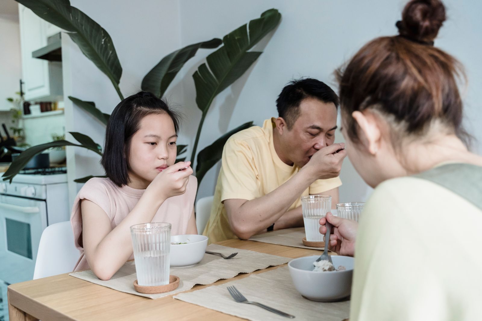 An Asian family sharing breakfast together at the home table